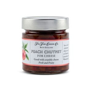 Jar of peach chutney labelled for cheese, England