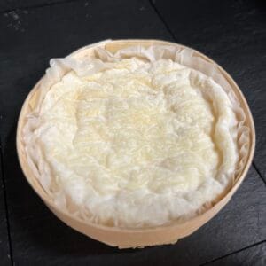 Close-up of fresh Camembert cheese in wooden box