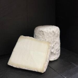 Brie and blue cheese on a black background