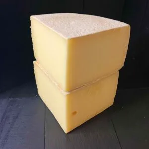 Two stacked blocks of mature cheddar cheese