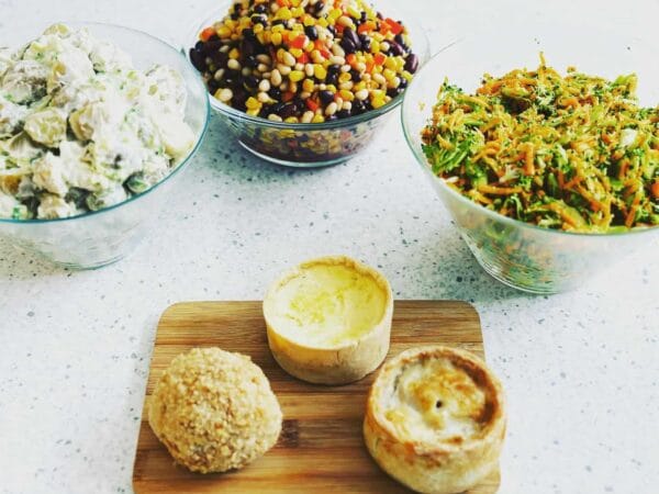 Assorted salads and pastries on kitchen countertop