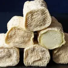 Assorted soft cheeses stacked close-up