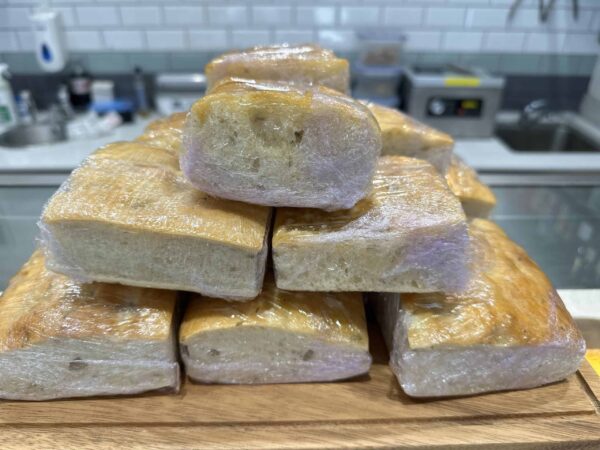 Stacked fresh baked bread on kitchen counter