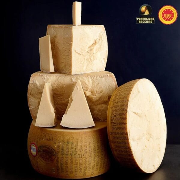 Stacked Parmigiano Reggiano cheese wheels and wedges