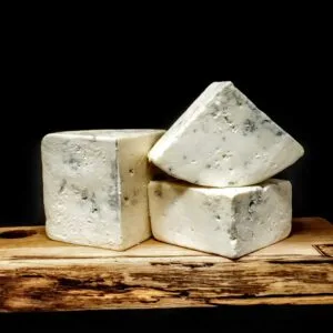 Blue cheese blocks on wooden serving board