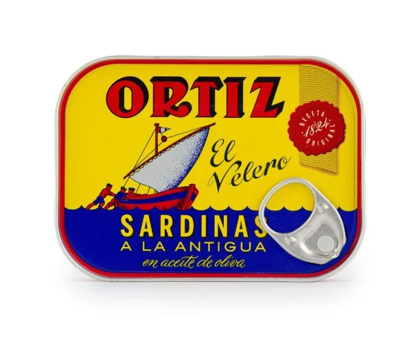 Colorful Ortiz sardine tin with traditional boat illustration