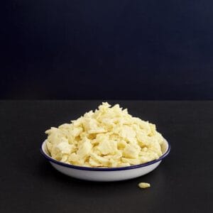 Bowl of scrambled eggs on dark background
