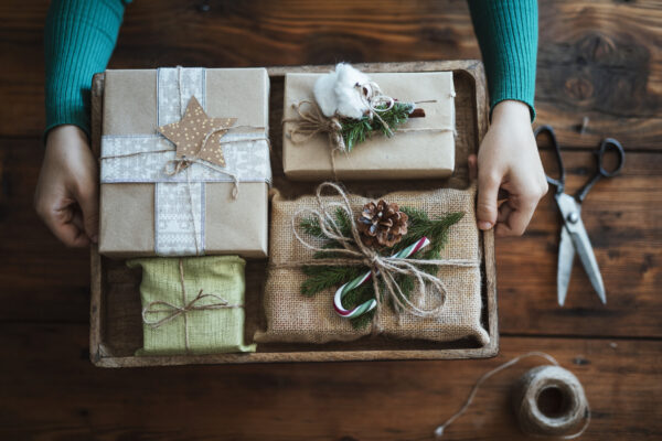 Person holding tray of rustic handmade Christmas gifts