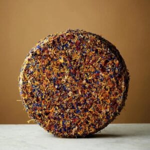 Colourful dried flower-covered spherical object on table