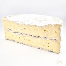 Slice of cream-layered sponge cake on white background