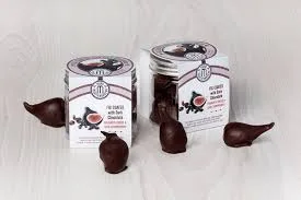 Chocolate sweets with packaging on wooden surface