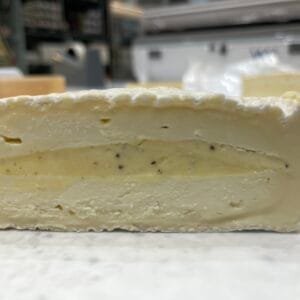 Close-up of a sliced brie cheese with rind