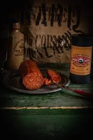 Sliced chorizo sausage on plate with mustard jar