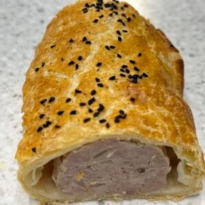 Close-up of sliced sausage roll with black sesame seeds