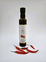 Chilli-infused olive oil bottle with red peppers