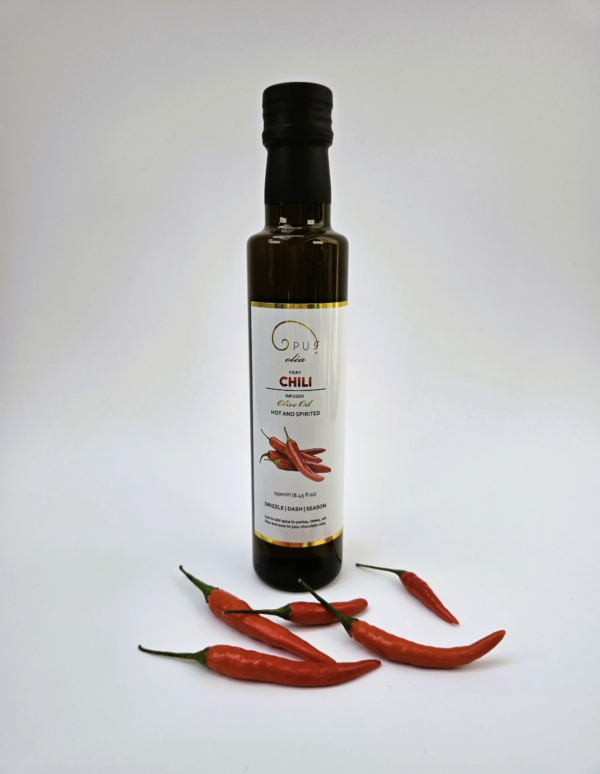 Bottle of chili-infused olive oil with fresh red chilies