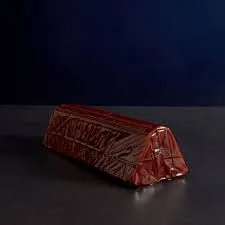 Red geometric patterned clutch bag on dark background