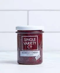 Jar of Morello Cherry Preserve on white backdrop