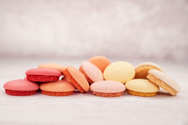 Assorted colourful macarons on light background