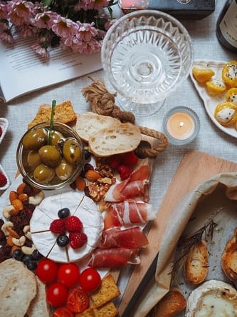 Elegant spread of charcuterie and cheese with flowers