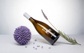 Wine bottle with lavender on white background