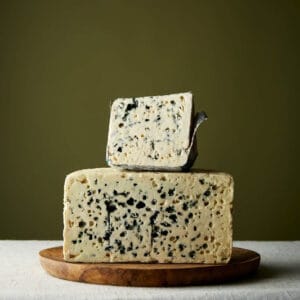 Blue Stilton cheese on wooden board