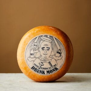 Cheese wheel with 'Drunk Monk' label design