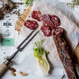 Artisan salami, rustic bread, fennel on wooden board