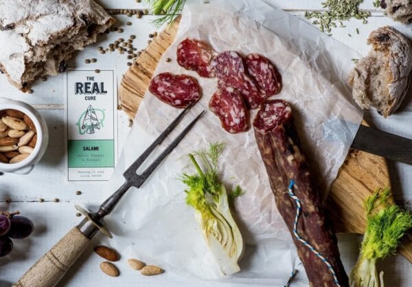 Artisan salami, rustic bread, fennel on wooden board