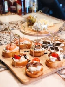 Assorted crostini appetisers on wooden serving board