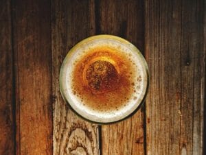 Top view of frothy espresso on rustic wooden table