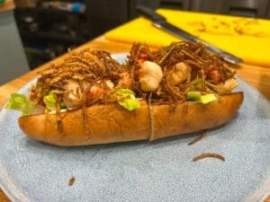 Seafood sandwich topped with crispy fried noodles