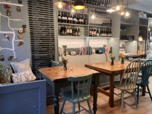 Cosy café interior with wooden tables and wine shelves