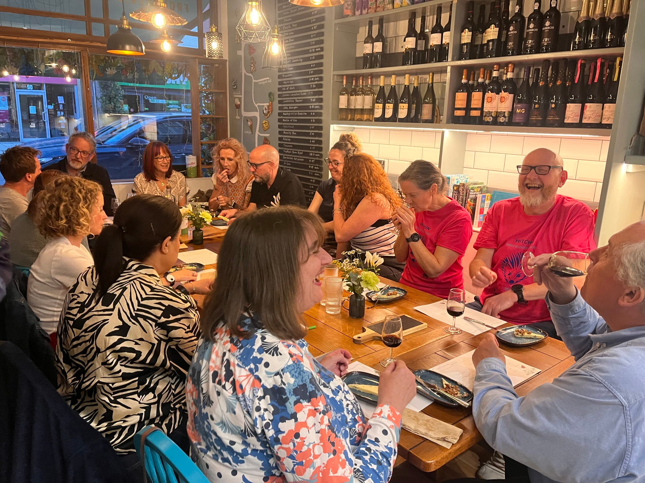 Friends dining in a busy wine bar restaurant